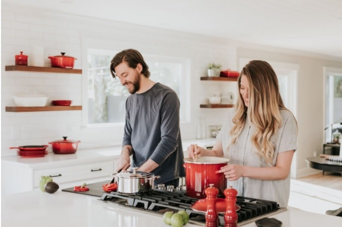 Young couple enjoying their newly renovateed, modern kitchen