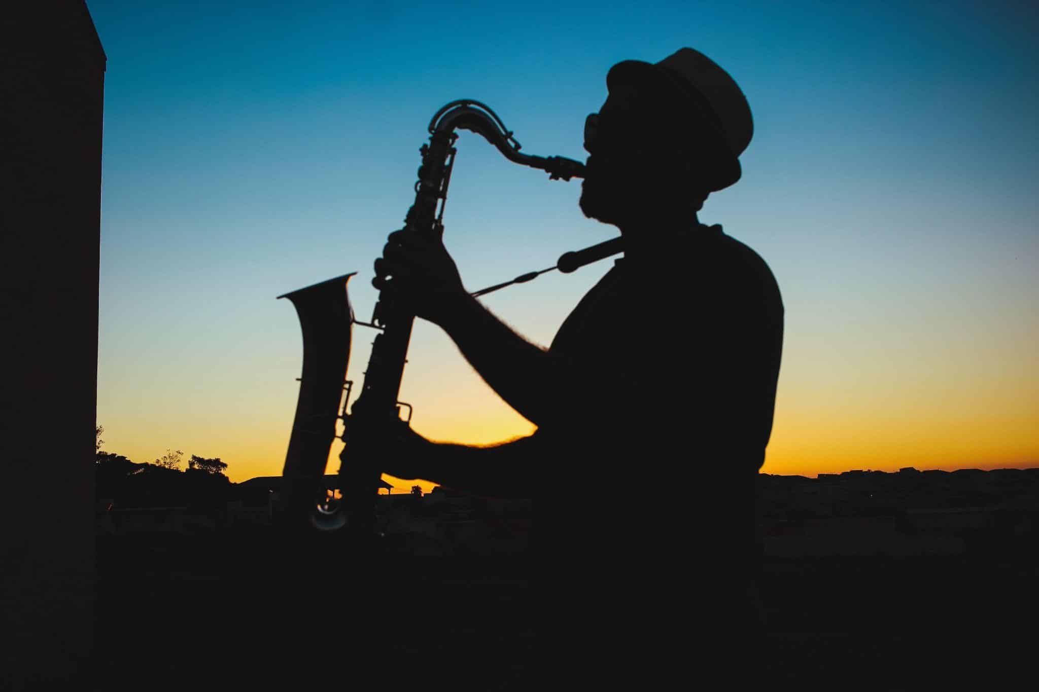 Silhouette of a person playing the saxophone
